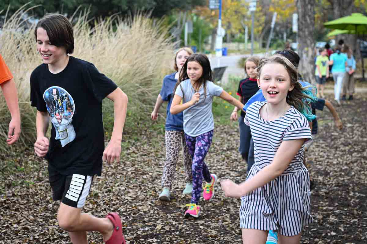 Students at micro school run outdoors together.