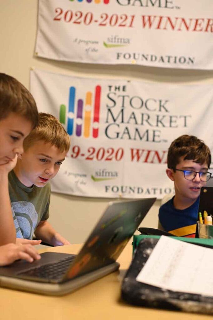 Non-religious private school students work on STEM skills playing stock market game.