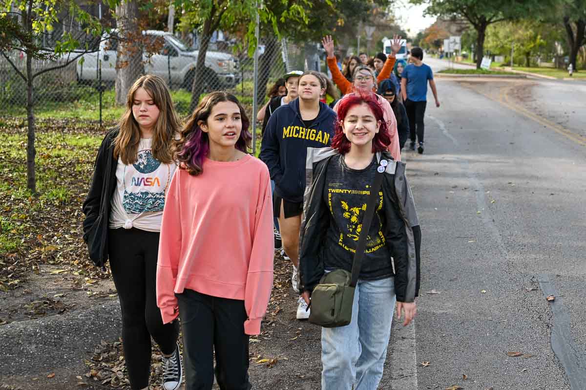 Private middle school students walk together outdoors.
